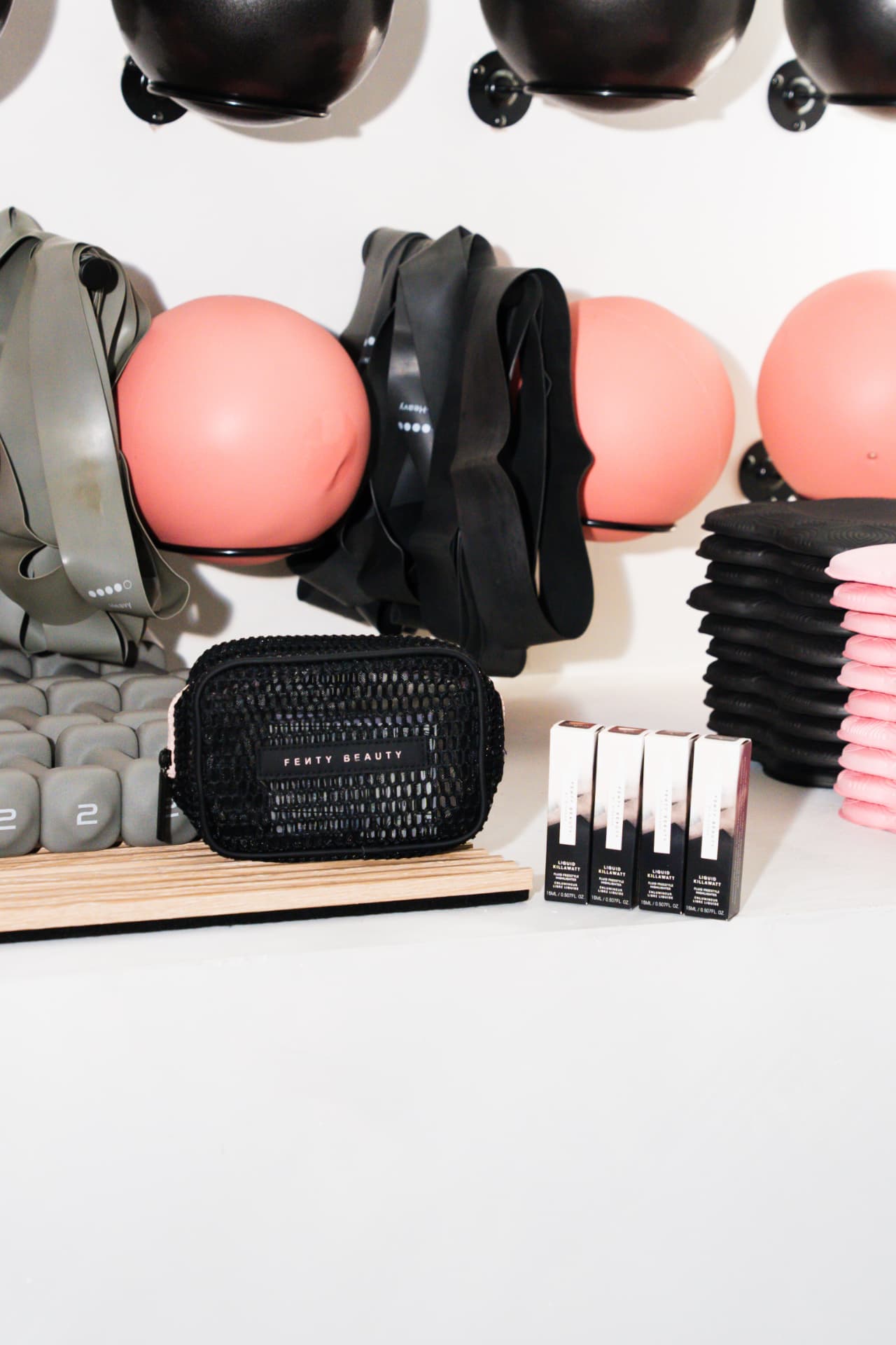 Fenty Beauty products displayed among studio equipment